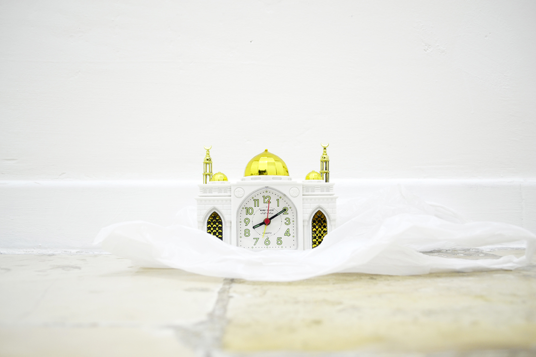 Imran Perretta, FAWAD, 2015, Emulsione e crema sbiancante per la pelle su coperte di sopravvivenza, borsa di polietilene, sveglia a forma di moschea, detail