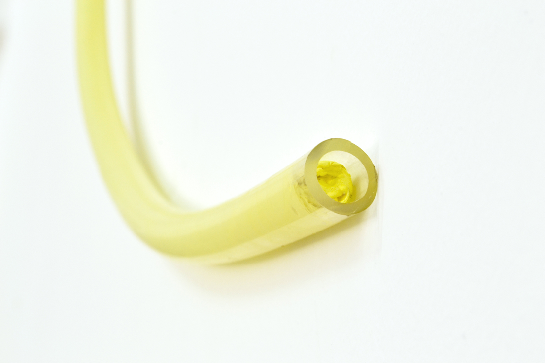 Mikko Kuorinki, Hit me in the nose so I can become someone else, 2016, mayonnaise, plastic tube, fixing clip (detail)