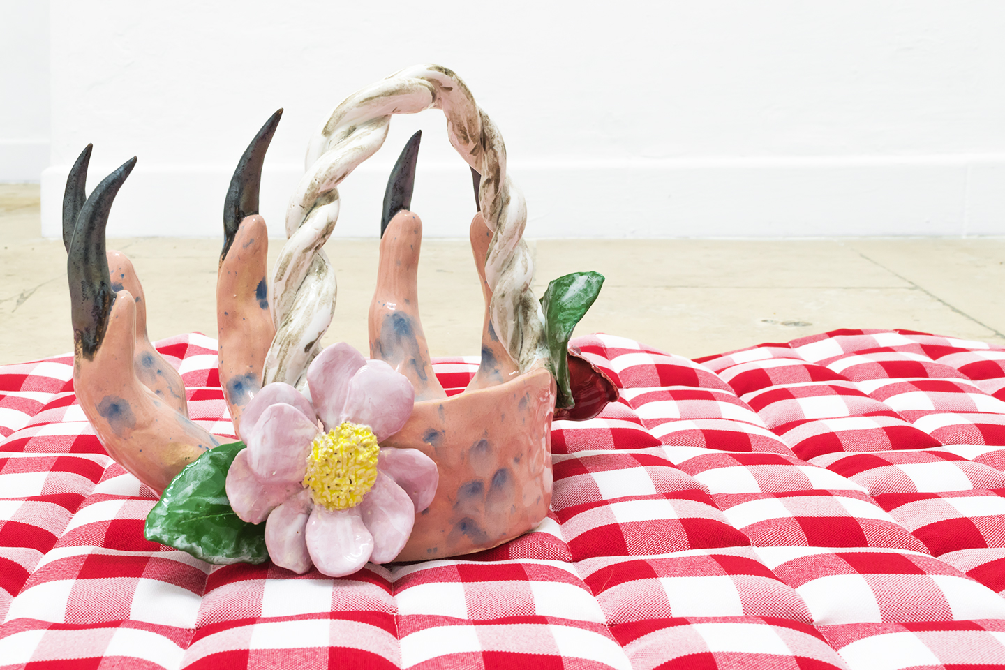 Naomi Gilon, Picnic with the wolf, 2019, glazed ceramics and wildflowers on padded tablecloth. 100x70x30 cm (detail)