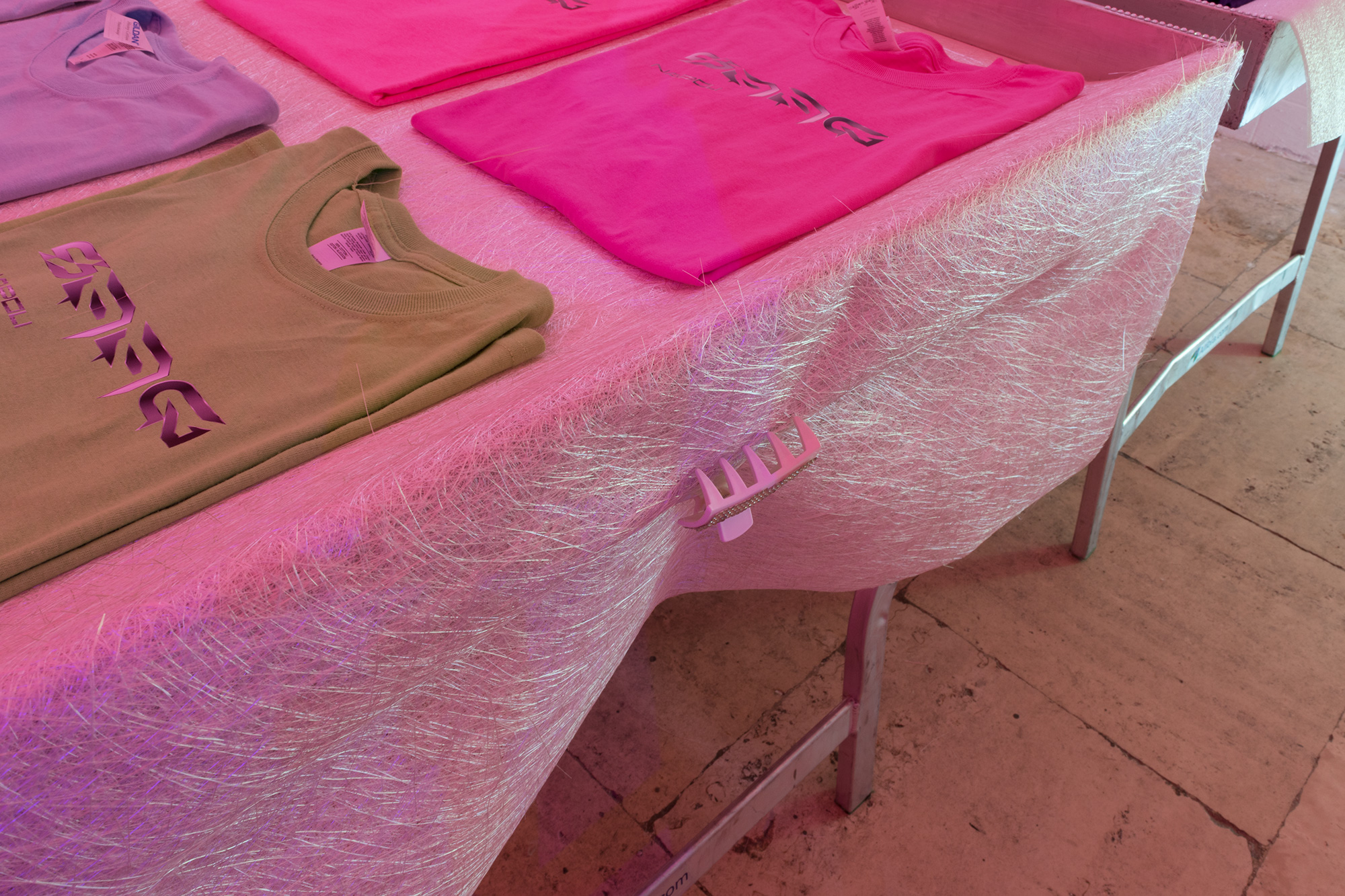 SAGG Napoli, ‘E cos favz s’appicn - Fake things are flamable, 2018  - Clothing stall, fake and original SAGG NAPOLI T-Shirts, lights, self adhesive fake crystals, hair clips, screwdriver. Environmental dimensions. (Detail)
